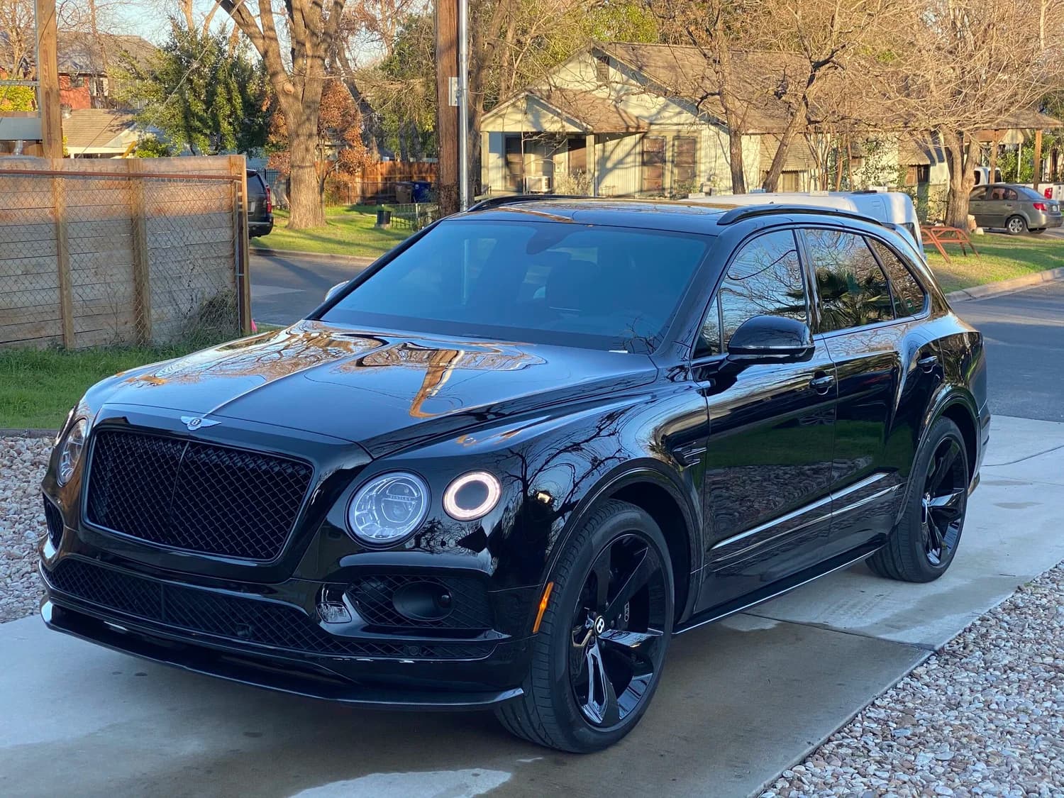 Freshly detailed black Bentley in an Austin driveway