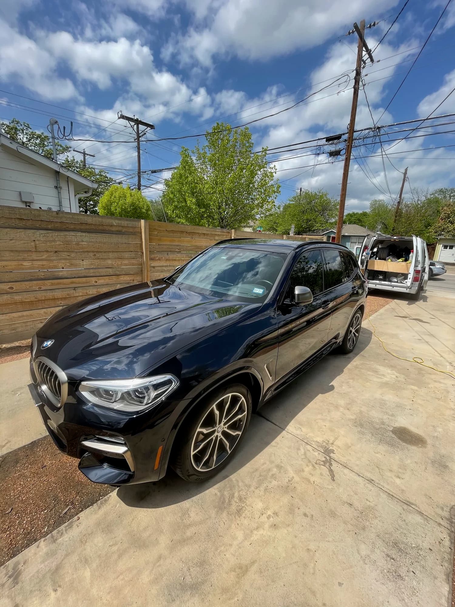 Black BMW X3 detailed in a driveway